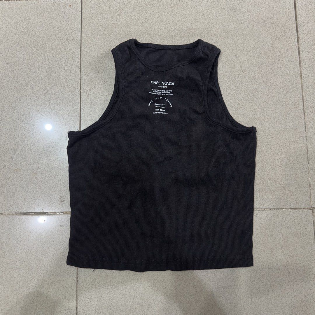 Black Ribbed Tank Top Cropped (Category: Sleeveless) located in Quezon City. Submitted by outyougoph (Listing ID 1470362097, Image 1). Description: - Brand: Darlingaga - Color: Black with white graphic text near the neckline - Style: Crew neck, cropped fit - Fabric: Stretchy, ribbed material - Fit/Pairing: Easy to style with high-waisted jeans or skirts - Condition: Great for casual, everyday wear.