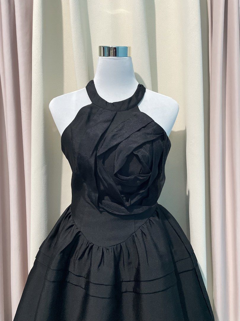 Black Rosette Halter Mini Dress (Category: Dresses) located in Taguig. Submitted by veronicakloset (Listing ID 1470360004, Image 2). Description: Black Rosette Halter Mini Dress 🖤 ✨Price: ₱250 | Like New | S-M Black halter mini dress with 3D fabric rose detail and a flattering flared skirt! Perfect for vintage-inspired outfits, coquette looks, formal parties, or a chic Halloween fit ✨🕯️ 📍 Pembo, Taguig 💌 DM to mine! Fixed price, no haggling. 