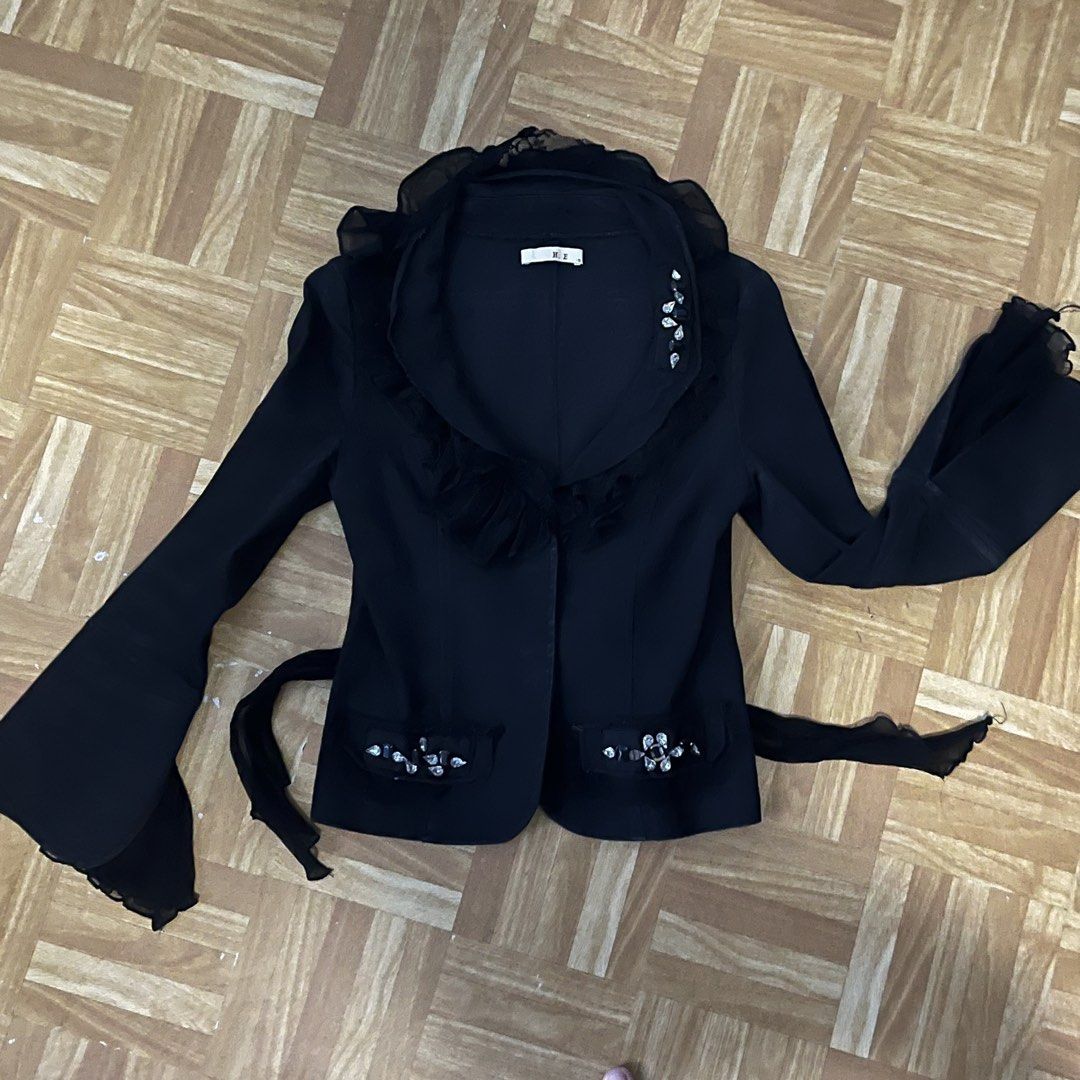 Black Ruffle Jacket with Rhinestones and Tie Back (Category: Coats, Jackets and Outerwear) located in Binan City. Submitted by peachilee (Listing ID 1470430463, Image 2). Description: - Brand/Model: H.E. - Size: S (Fitted silhouette) - Color: Black - Key Features: Layered ruffle collar, flare sleeves, and rhinestone embellishments on lapel and pockets - Details: Adjustable sheer fabric tie closure in the back, lightweight material - Note: Measure
