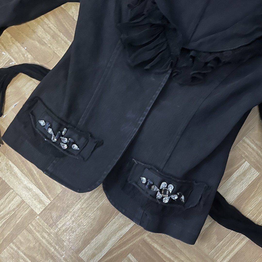 Black Ruffle Jacket with Rhinestones and Tie Back (Category: Coats, Jackets and Outerwear) located in Binan City. Submitted by peachilee (Listing ID 1470430463, Image 3). Description: - Brand/Model: H.E. - Size: S (Fitted silhouette) - Color: Black - Key Features: Layered ruffle collar, flare sleeves, and rhinestone embellishments on lapel and pockets - Details: Adjustable sheer fabric tie closure in the back, lightweight material - Note: Measure