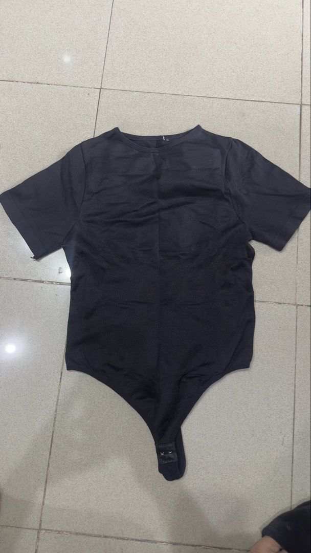 Black short sleeve bodysuit thong style (Category: Others Tops) located in Quezon City. Submitted by outyougoph (Listing ID 1470362535, Image 1). Description: - Color: Black - Style: Short sleeve round neckline bodysuit with thong bottom and snap crotch closure - Material: Stretchy ribbed fabric - Fit: Basic everyday top, perfect for layering under jeans or skirts - Condition: Excellent, clean with no stains or rips.