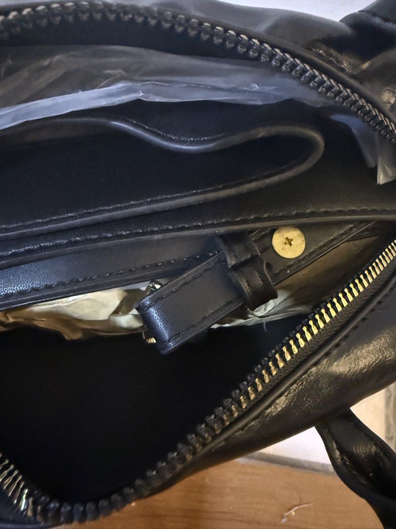 Black Structured Handbag with Detachable Strap (Category: Shoulder Bags) located in Bulacan. Submitted by emjay_17 (Listing ID 1470404976, Image 3). Description: - Color: Black - Material: Premium faux leather with gold-tone hardware - Dimensions: Approx. 22cm (L) x 15cm (H) - Compartments: Secure main zip closure with 1 interior slip pocket - Straps: Dual top carry handles + adjustable/removable shoulder strap - Condition: Brand new / Excellent 