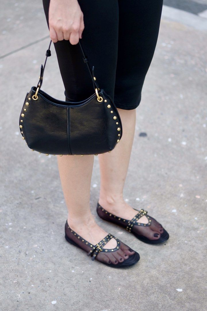 Black Studded Shoulder Bag with Gold Hardware (Category: Luxury Bags & Wallets) located in Caloocan City. Submitted by shopmyclosetttttt (Listing ID 1470399086, Image 1). Description: - Material: Glossy black faux leather - Details: Chic gold dome studs along curved edges and seams - Strap: Single strap with metal rings - Size: Compact hobo shape, fits phone, wallet, and daily essentials - Condition: Clean interior and exterior -It was a gift, so