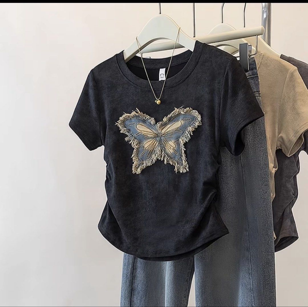 Black T-Shirt with Distressed Denim Butterfly Patch (Category: Shirts) located in Baguio. Submitted by declutterbycys (Listing ID 1470386227, Image 1). Description: - Color: Black with worn-in wash look - Design: Frayed denim butterfly appliqué on front - Fit: Casual slim fit with a classic round neckline - Fabric: Soft and comfortable for all-day wear - Style: Great everyday piece, easy to pair with your favorite jeans.
