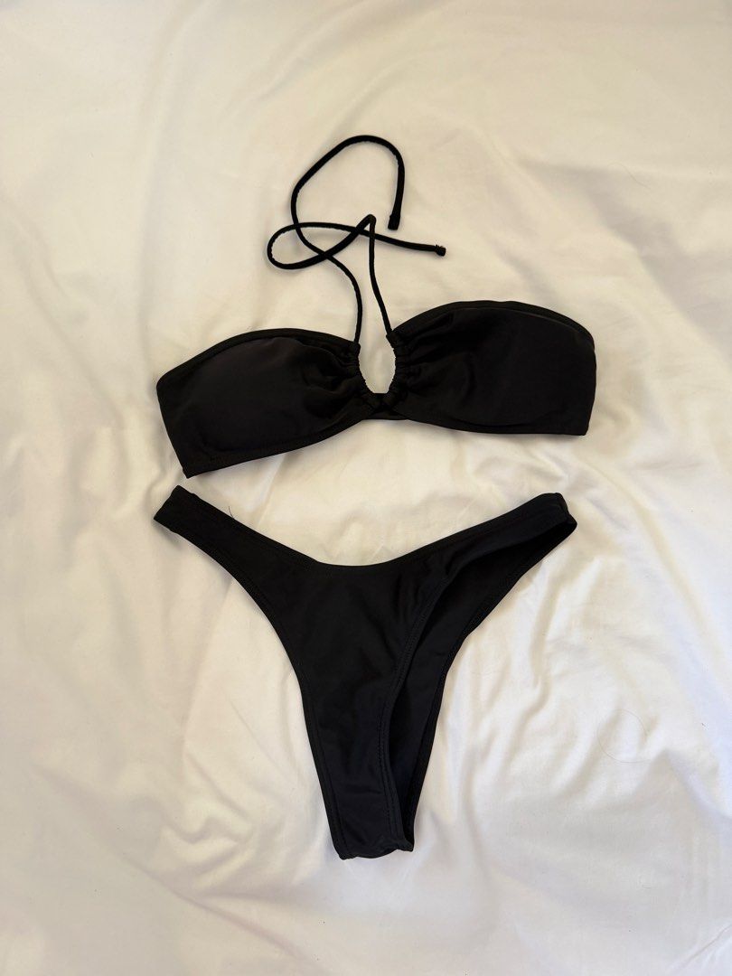 Black two-piece bikini swimsuit with halter neck (Category: Bikinis & Swimsuits) located in Binan City. Submitted by wornbygwen (Listing ID 1470489810, Image 1). Description: - Style: Two-piece swimsuit with bandeau top and high-cut bottoms - Top Details: Gathered center ring with optional thin halter straps - Bottoms: High-cut with cheeky coverage - Color: Classic solid black (easy to mix and match) - Condition: Clean fabric with minimal wear - 