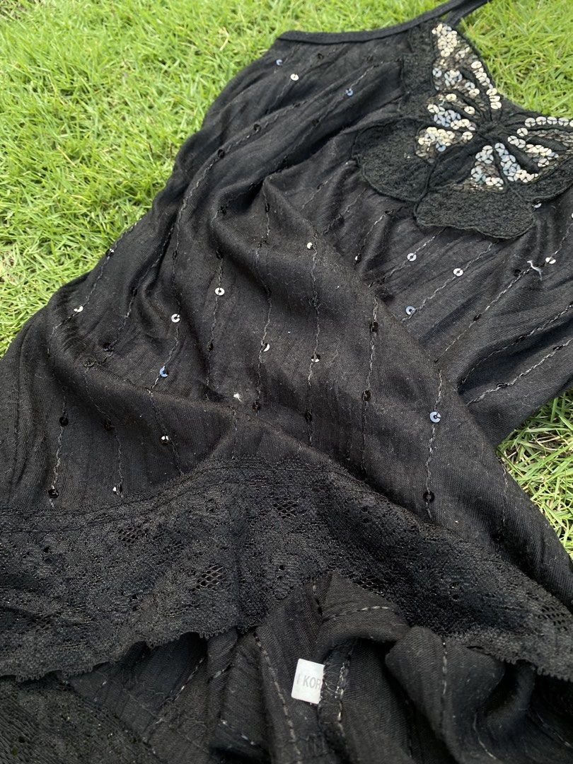 Black Y2K Sequinned Butterfly Cami Top (Category: Sleeveless) located in Roxas City. Submitted by dua-garments23 (Listing ID 1470445159, Image 3). Description: - Color: Black - Style: Spaghetti strap cami top with vertical sequin stripes - Details: Large sequinned butterfly patch on the neckline and delicate lace trim along the bottom hem - Material: Soft, lightweight knit fabric - Origin: Made in Korea - Condition: Excellent, ready to wear.