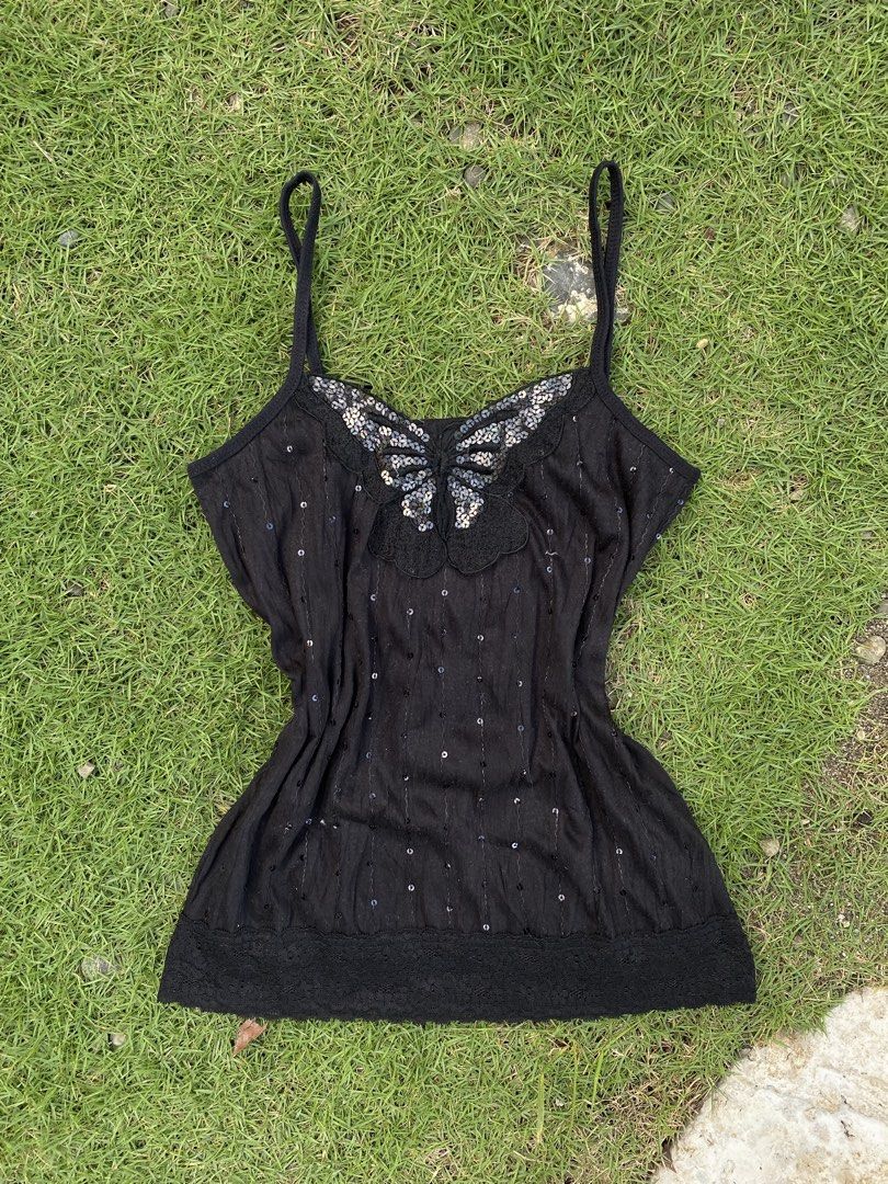 Black Y2K Sequinned Butterfly Cami Top (Category: Sleeveless) located in Roxas City. Submitted by dua-garments23 (Listing ID 1470445159, Image 1). Description: - Color: Black - Style: Spaghetti strap cami top with vertical sequin stripes - Details: Large sequinned butterfly patch on the neckline and delicate lace trim along the bottom hem - Material: Soft, lightweight knit fabric - Origin: Made in Korea - Condition: Excellent, ready to wear.