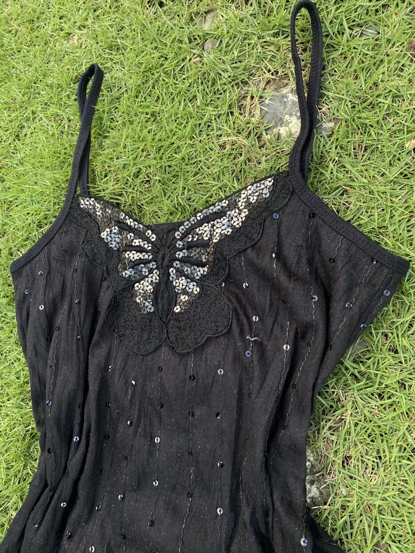 Black Y2K Sequinned Butterfly Cami Top (Category: Sleeveless) located in Roxas City. Submitted by dua-garments23 (Listing ID 1470445159, Image 2). Description: - Color: Black - Style: Spaghetti strap cami top with vertical sequin stripes - Details: Large sequinned butterfly patch on the neckline and delicate lace trim along the bottom hem - Material: Soft, lightweight knit fabric - Origin: Made in Korea - Condition: Excellent, ready to wear.