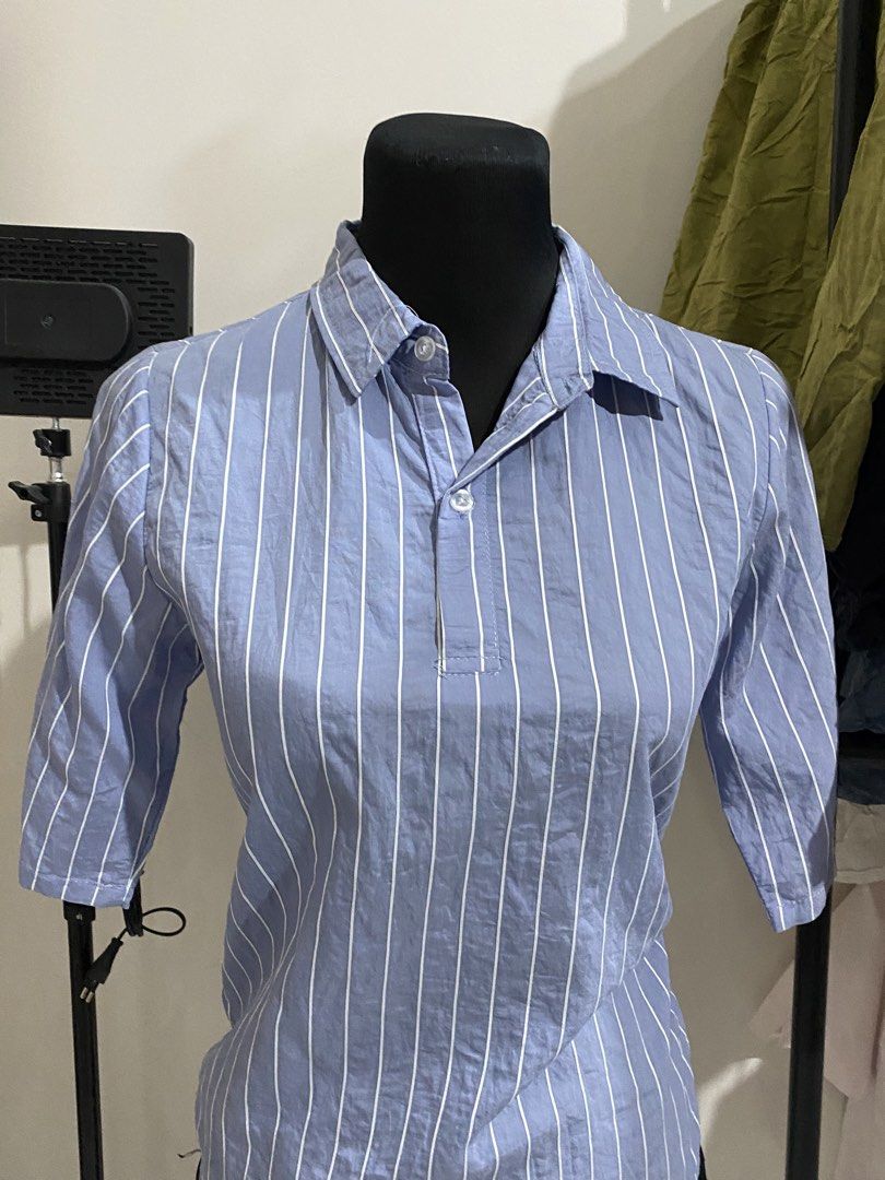 Blue and White Striped Half Sleeve Collared Blouse (Category: Blouses) located in Manila. Submitted by mpt99876 (Listing ID 1470496510, Image 2). Description: - Color & Pattern: Blue with vertical white stripes - Style: Collared blouse with half-length sleeves and chest button placket - Versatility: Perfect for office wear or casual outings - Pairing: Easily matches with skirts or trousers - Condition: Brand new / Excellent quality.