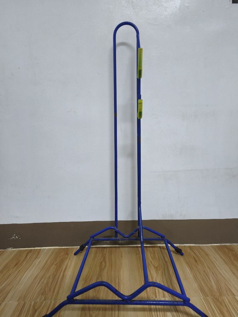Blue Bike Stand (Heavy Duty) (Category: Bicycles) located in Alaminos. Submitted by fayesbook (Listing ID 1470408456, Image 1). Description: - Blue metal vertical bicycle stand - Fits one bike securely by the wheel and frame - Yellow rubberized hooks keep the frame steady - Sturdy base prevents tipping and saves garage space - Condition: Minor rust spots on the metal frame from previous use.
