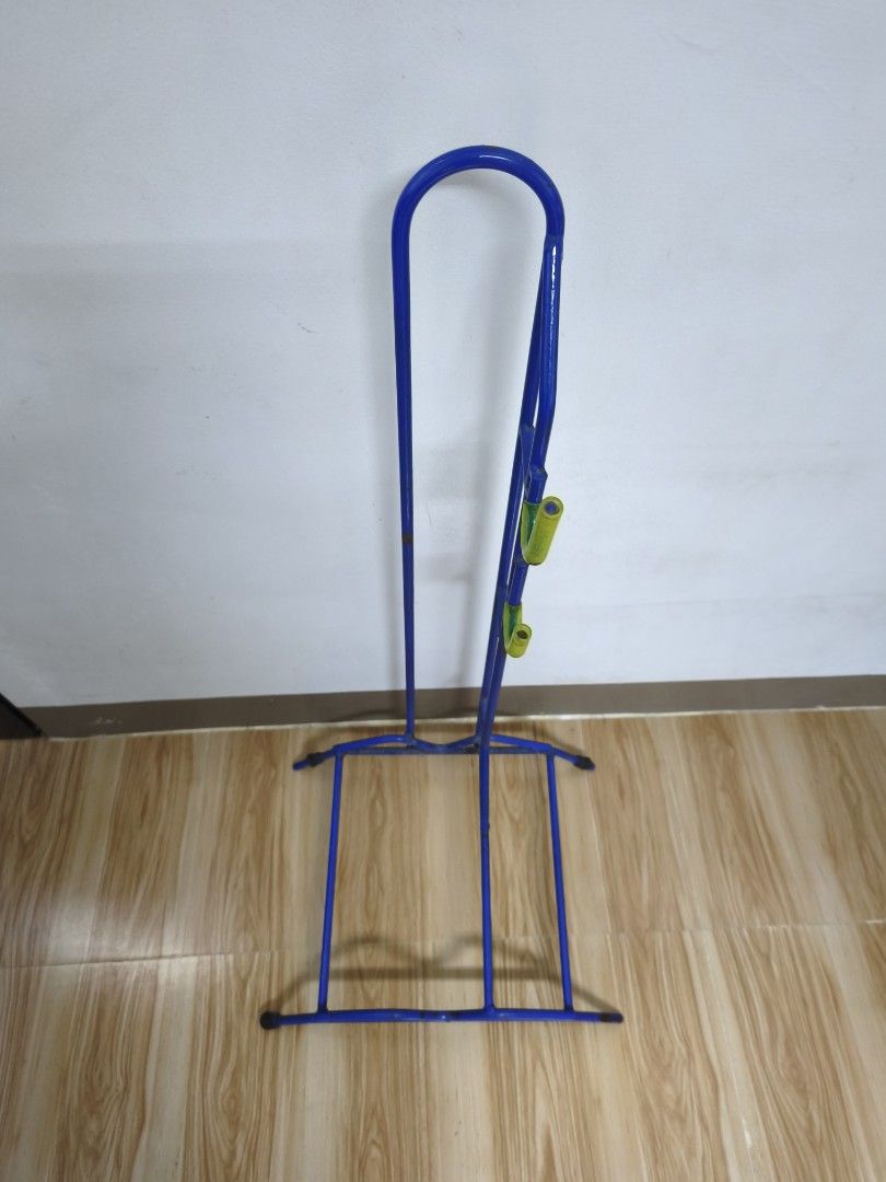 Blue Bike Stand (Heavy Duty) (Category: Bicycles) located in Alaminos. Submitted by fayesbook (Listing ID 1470408456, Image 2). Description: - Blue metal vertical bicycle stand - Fits one bike securely by the wheel and frame - Yellow rubberized hooks keep the frame steady - Sturdy base prevents tipping and saves garage space - Condition: Minor rust spots on the metal frame from previous use.