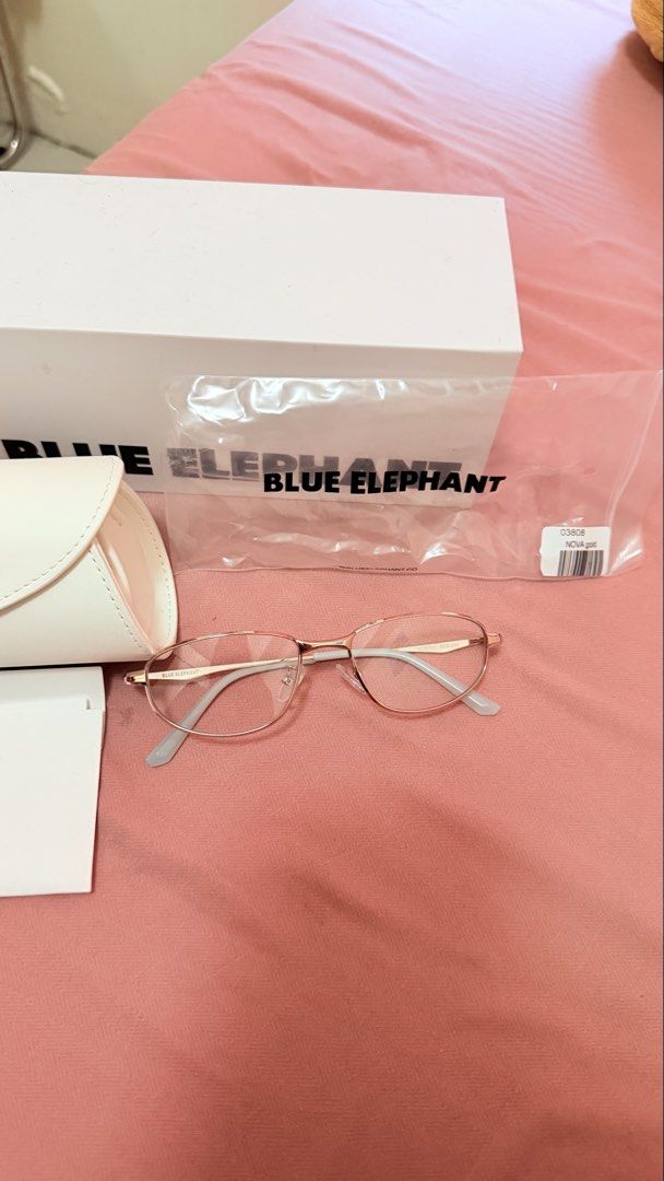 Blue Elephant 03808 Nova Gold Eyeglasses with Case (Category: Sunglasses & Eyewear) located in Manila. Submitted by butter.g13 (Listing ID 1470556870, Image 3). Description: - Brand: Blue Elephant - Model: Nova - Color: Gold (metal wire design) - Lenses: Clear (unworn condition) - Inclusions: Original white hard case, branded box, plastic dust bag, and certification cards from the Seongsu flagship store dated 2025 - Condition: 100% brand new and 
