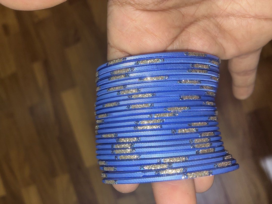 Blue glitter bangles stack set (Category: Bracelets) located in Singapore. Submitted by buycarous (Listing ID 1470369023, Image 3). Description: - Vibrant bright blue color with eye-catching glitter accents - Features unique textured line designs - Versatile stackable set (includes all pieces shown in photos) - Perfect accessory for traditional outfits, parties, or everyday styling - Scale and size clearly shown in listing photos.