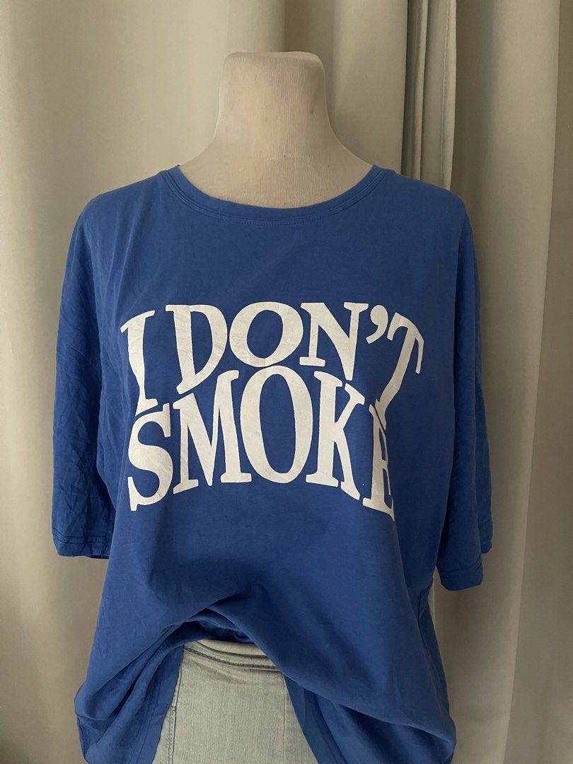 Blue KTEE (Category: Tshirts & Polo Shirts ) located in Cainta. Submitted by zlove111 (Listing ID 1470456067, Image 2). Description: - Color: Bright blue with large white 'I Don't Smoke' text on the chest - Fit: Relaxed, oversized fit for daily casual wear - Material: Soft and comfortable cotton - Details: Classic crew neckline and short sleeves up to xl 22" .