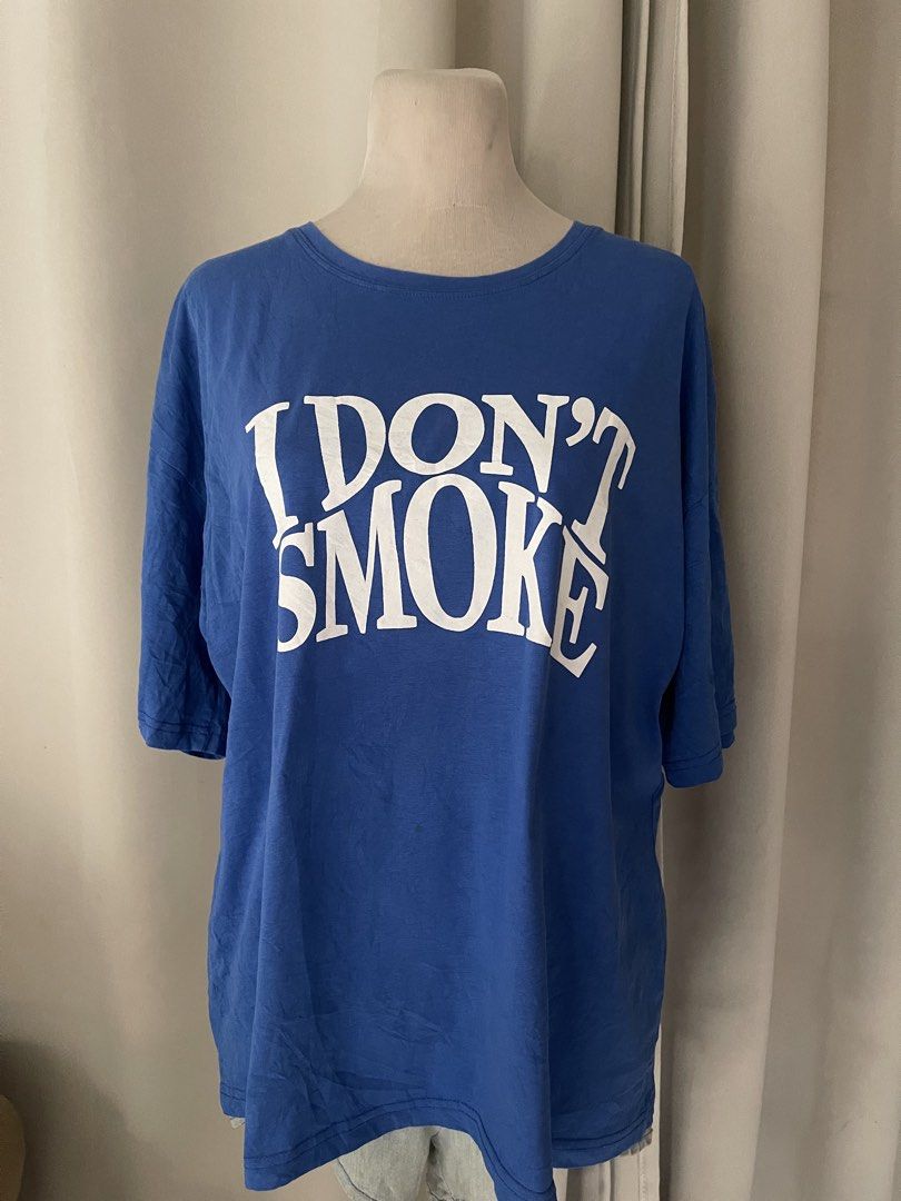 Blue KTEE (Category: Tshirts & Polo Shirts ) located in Cainta. Submitted by zlove111 (Listing ID 1470456067, Image 1). Description: - Color: Bright blue with large white 'I Don't Smoke' text on the chest - Fit: Relaxed, oversized fit for daily casual wear - Material: Soft and comfortable cotton - Details: Classic crew neckline and short sleeves up to xl 22" .