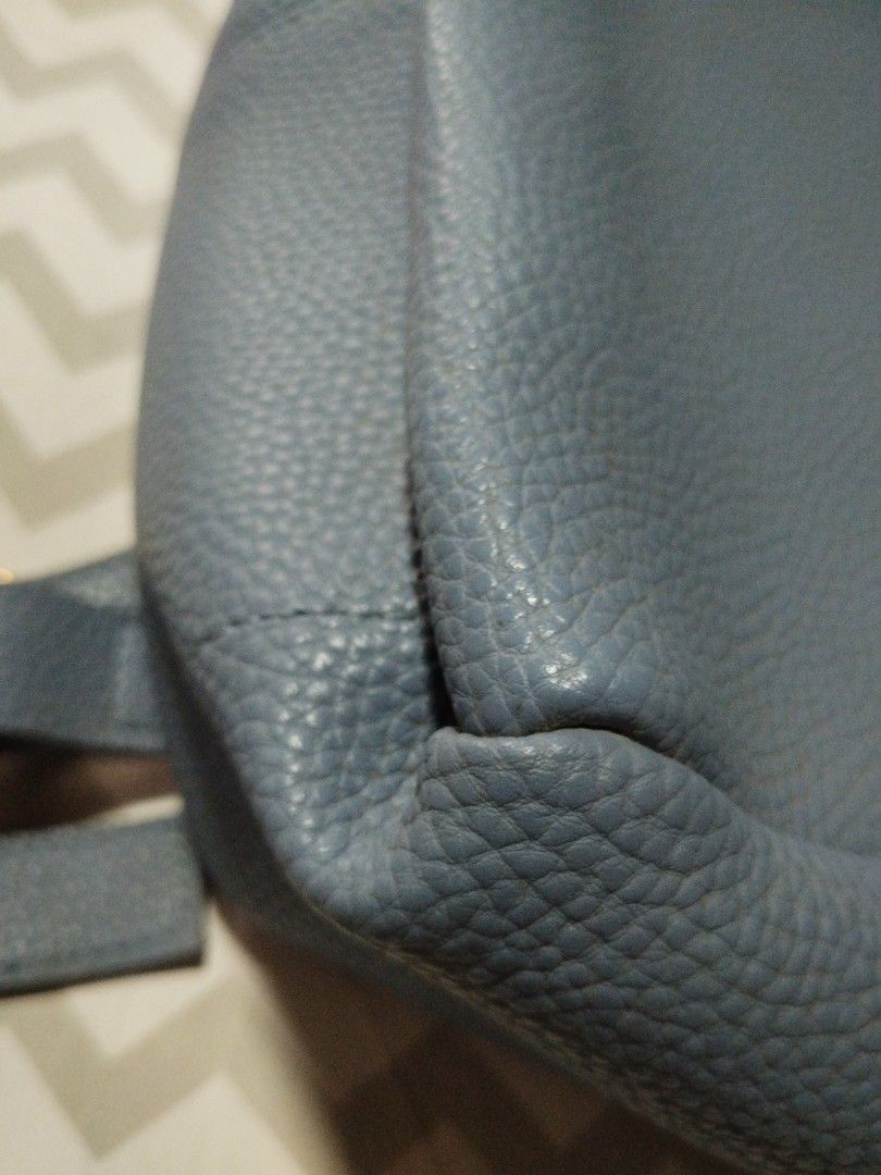 Blue leather backpack with flap closure and adjustable straps (Category: Backpacks) located in Manila. Submitted by lene48 (Listing ID 1470349548, Image 2). Description: Textured blue leather backpack with front flap and magnetic snap closure. Includes a top grab handle and adjustable shoulder straps on the back. Drawstring closure under the main flap. Compact size for daily essentials. Clean stitching throughout .