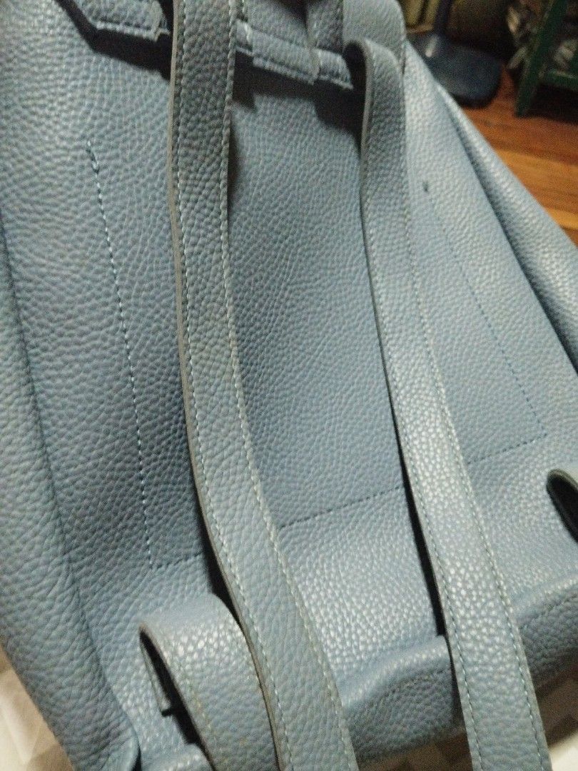 Blue leather backpack with flap closure and adjustable straps (Category: Backpacks) located in Manila. Submitted by lene48 (Listing ID 1470349548, Image 3). Description: Textured blue leather backpack with front flap and magnetic snap closure. Includes a top grab handle and adjustable shoulder straps on the back. Drawstring closure under the main flap. Compact size for daily essentials. Clean stitching throughout .