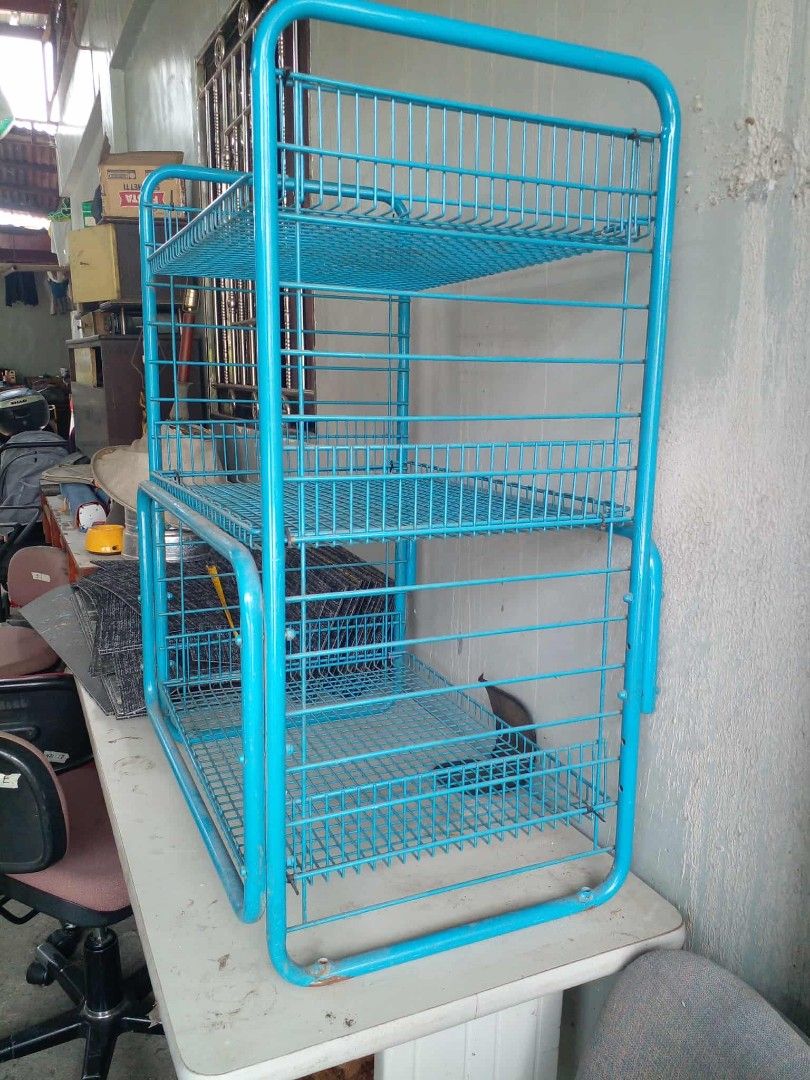 Blue metal 3-tier wire basket storage rack (Category: Storage Boxes & Baskets) located in Manila. Submitted by wisegem-231b (Listing ID 1470404701, Image 3). Description: - Color: Blue - 3 tiers of open wire mesh baskets - Sturdy frame construction for heavy-duty storage - Versatile use: ideal for kitchen supplies, pantry items, or office clutter - Can stand upright on a tabletop or floor - Clean look and ready to use.