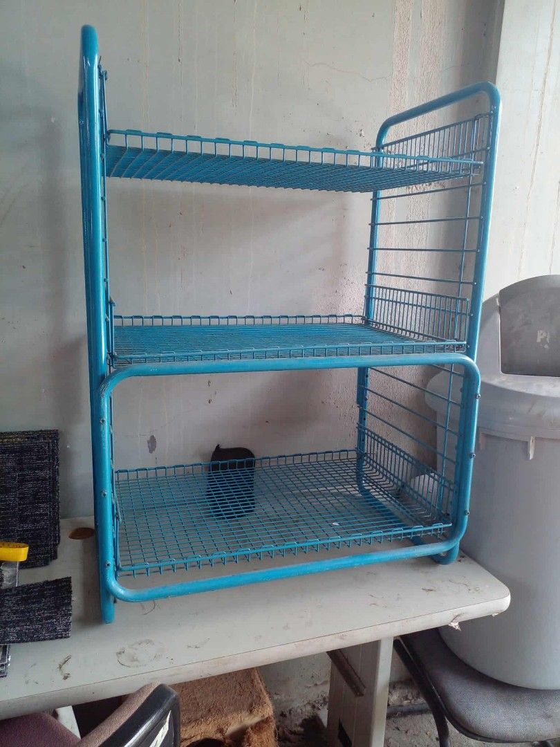 Blue metal 3-tier wire basket storage rack (Category: Storage Boxes & Baskets) located in Manila. Submitted by wisegem-231b (Listing ID 1470404701, Image 1). Description: - Color: Blue - 3 tiers of open wire mesh baskets - Sturdy frame construction for heavy-duty storage - Versatile use: ideal for kitchen supplies, pantry items, or office clutter - Can stand upright on a tabletop or floor - Clean look and ready to use.