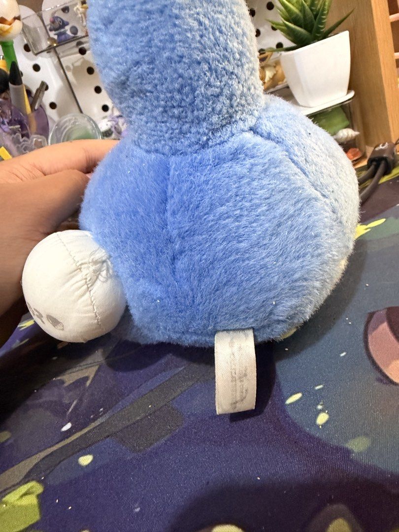 Blue Totoro plush toy Studio Ghibli (Category: Plushies & Soft Toys) located in Baguio. Submitted by jonathanseller_buyer (Listing ID 1470514416, Image 3). Description: - Character: Blue Totoro from Studio Ghibli holding a white bundle with Japanese text - Condition: Pre-loved with minor gray marks and spots on the white belly - Features: Soft texture, cute tail extending backward, and fabric tag at the back bottom - Perfect for: Ghibli collector
