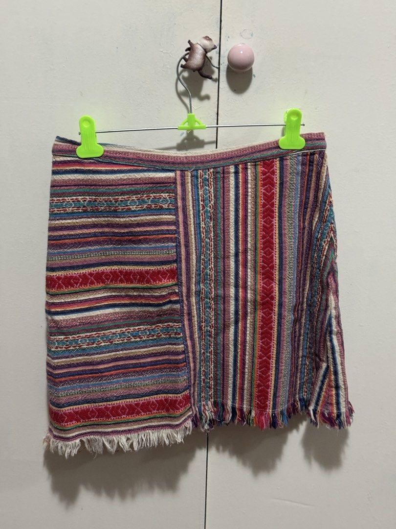 Boho Woven Striped Patchwork Mini Skirt with Fringe (Category: Skirts) located in Angeles City. Submitted by m1lkramen (Listing ID 1470475076, Image 2). Description: - Style: Boho multi-colored woven mini skirt - Design: Unique patchwork with vertical and horizontal stripes in red, blue, purple, and beige - Details: Trendy raw fringe hem at the bottom - Fit: High-waisted, hits around mid-thigh - Fabric: Great textured material, easy to pair with 