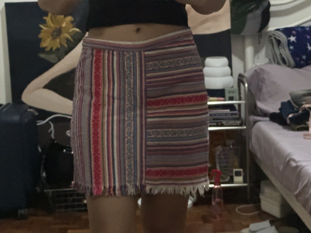 Boho Woven Striped Patchwork Mini Skirt with Fringe (Category: Skirts) located in Angeles City. Submitted by m1lkramen (Listing ID 1470475076, Image 1). Description: - Style: Boho multi-colored woven mini skirt - Design: Unique patchwork with vertical and horizontal stripes in red, blue, purple, and beige - Details: Trendy raw fringe hem at the bottom - Fit: High-waisted, hits around mid-thigh - Fabric: Great textured material, easy to pair with 
