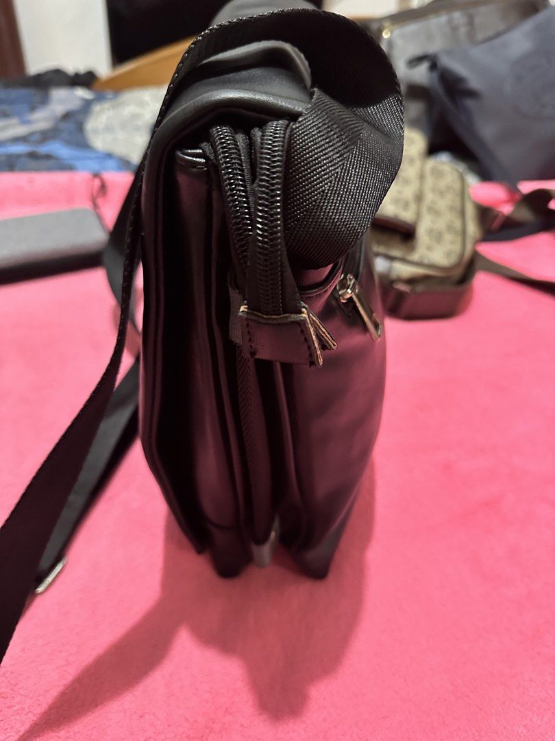 BOSS Black Crossbody Sling Bag (Category: Sling Bags) located in Quezon City. Submitted by pongoy (Listing ID 1470392287, Image 2). Description: - Brand: BOSS - Color: Black - Material: Smooth synthetic with embossed front logo - Organization: Multiple zippered compartments & back slip pocket - Strap: Adjustable webbing for shoulder or crossbody wear - Condition: Clean inside and out, ready for daily use.