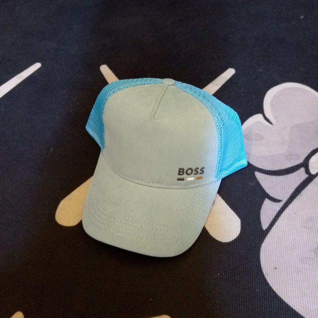 BOSS Blue Trucker Hat Cap (Category: Caps & Hats) located in Manila. Submitted by pablopresk0. (Listing ID 1470508014, Image 1). Description: - Brand: BOSS - Color: Light blue with vibrant blue mesh back - Design: Structured front crown with BOSS logo and three colored accent blocks - Fit: Adjustable plastic snapback closure - Details: Interior brim and lining feature signature BOSS branding - Condition: Clean shape, breathable mesh panels for ai