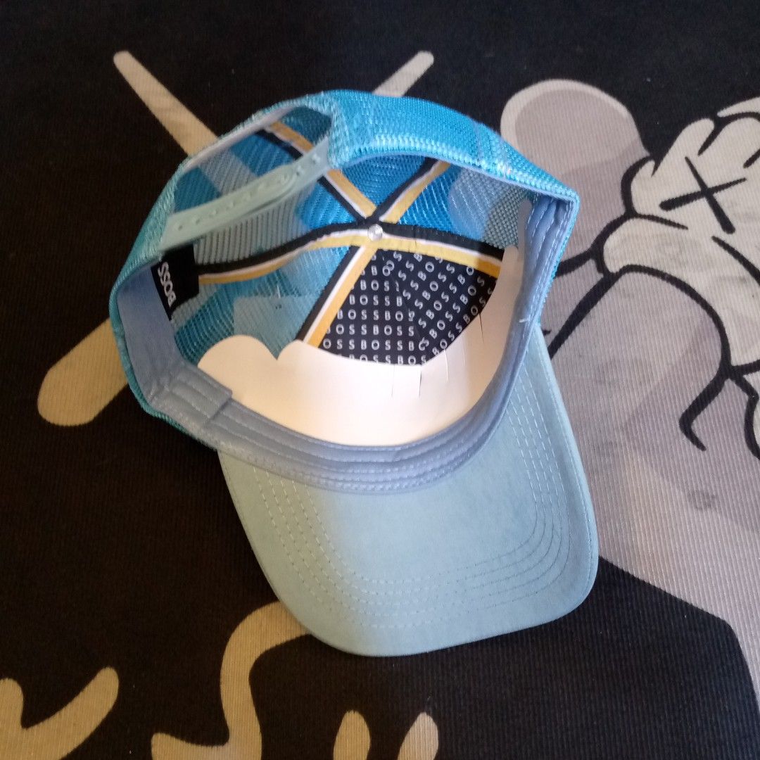 BOSS Blue Trucker Hat Cap (Category: Caps & Hats) located in Manila. Submitted by pablopresk0. (Listing ID 1470508014, Image 3). Description: - Brand: BOSS - Color: Light blue with vibrant blue mesh back - Design: Structured front crown with BOSS logo and three colored accent blocks - Fit: Adjustable plastic snapback closure - Details: Interior brim and lining feature signature BOSS branding - Condition: Clean shape, breathable mesh panels for ai