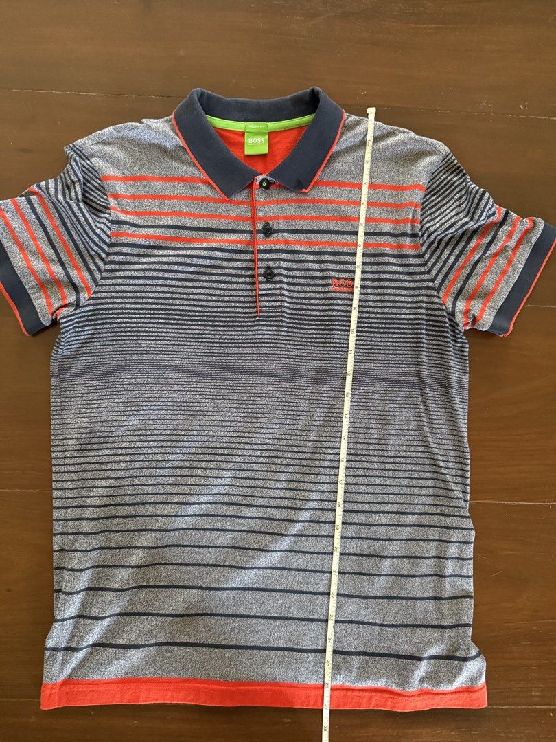 Hugo Boss Polo Shirt (Category: Tshirts & Polo Shirts ) located in Angeles City. Submitted by gillian_a (Listing ID 1470419247, Image 2). Description: Color: Grey with orange stripes Size: L (Modern Fit) No defects Check photos for dimensions/measurements.