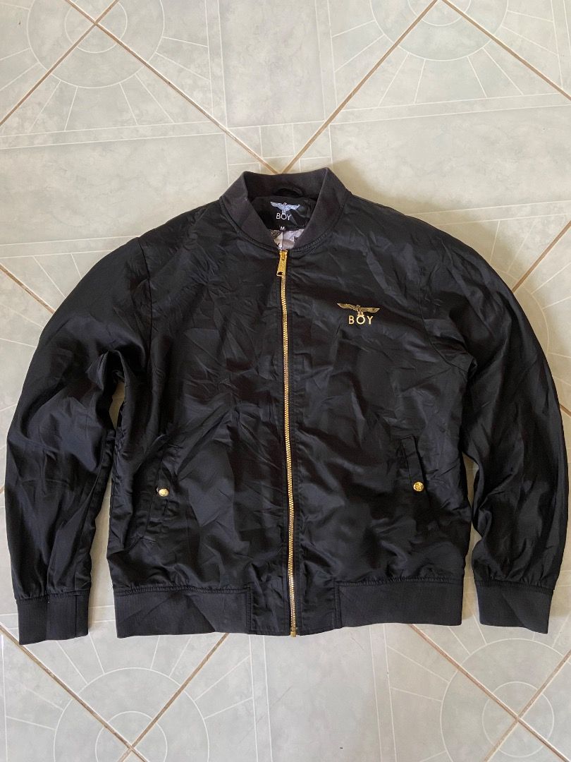 Boy London Embroidered Jacket (Category: Coats, Jackets and Outerwear) located in Caloocan City. Submitted by koolkids1994 (Listing ID 1470516266, Image 1). Description: Selling an authentic, pre-loved Boy London Bomber Jacket in excellent condition. • Color: Sleek Black with Gold accents • Size: Medium (M / 175/92A) • Model Code: B211NN103802 D12 • Material: 100% Nylon Shell / 100% Polyester Lining • Design Features: • Gold embroidered "BOY" log