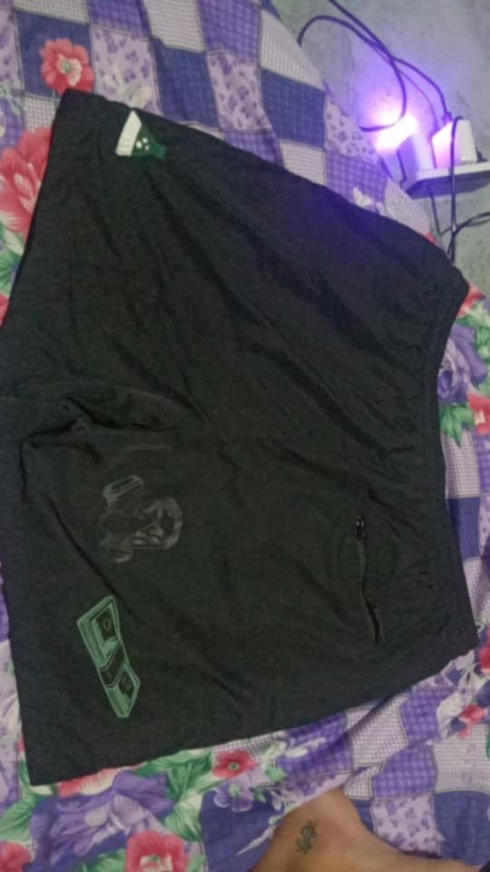 Breaking Bad Walter White Graphic Print Shorts Black (Category: Shorts) located in Tanay. Submitted by _justdothrift (Listing ID 1470525921, Image 2). Description: - Design: Black Breaking Bad shorts with Walter White counting money graphic on the leg - Details: Iconic logo embroidery near the hem and a small fly icon design - Waistband: Comfortable elastic waistband with adjustable black drawstrings - Pocket: Convenient zippered back pocket for 