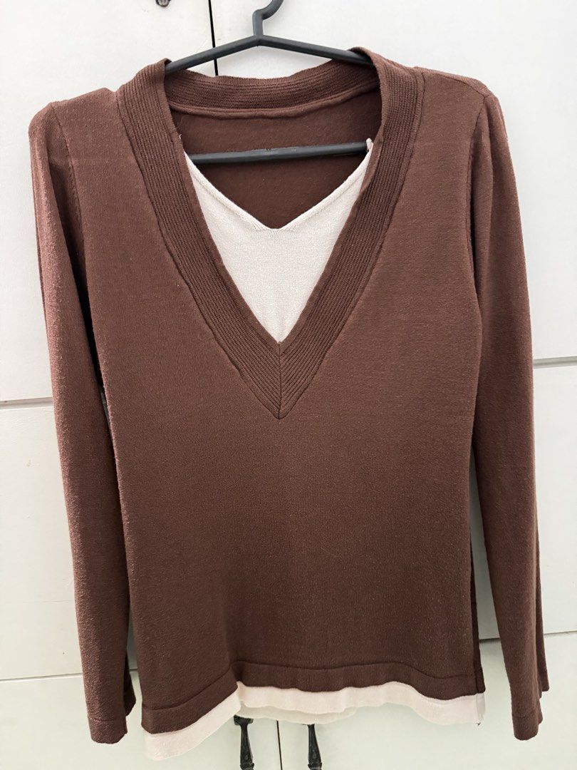 Brown Layered V-Neck Long Sleeve Sweater (Category: Coats, Jackets and Outerwear) located in Manila. Submitted by mnlclaudia (Listing ID 1470509964, Image 2). Description: - Color: Brown with white layered V-neck and hem trim - Material: Lightweight knit fabric - Design: Long sleeves, ribbed collar, built-in layered detail - Style: Casual and easy to match with jeans or skirts - Perfect for cooler weather.