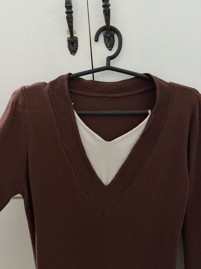 Brown Layered V-Neck Long Sleeve Sweater (Category: Coats, Jackets and Outerwear) located in Manila. Submitted by mnlclaudia (Listing ID 1470509964, Image 1). Description: - Color: Brown with white layered V-neck and hem trim - Material: Lightweight knit fabric - Design: Long sleeves, ribbed collar, built-in layered detail - Style: Casual and easy to match with jeans or skirts - Perfect for cooler weather.