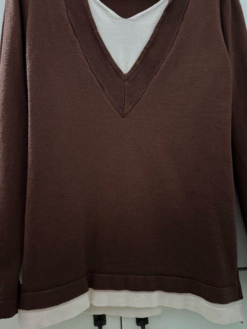 Brown Layered V-Neck Long Sleeve Sweater (Category: Coats, Jackets and Outerwear) located in Manila. Submitted by mnlclaudia (Listing ID 1470509964, Image 3). Description: - Color: Brown with white layered V-neck and hem trim - Material: Lightweight knit fabric - Design: Long sleeves, ribbed collar, built-in layered detail - Style: Casual and easy to match with jeans or skirts - Perfect for cooler weather.