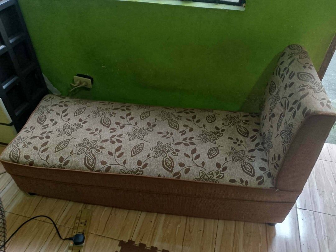 Brown patterned lounge sofa with matching stool (Category: Sofas) located in Manila. Submitted by wisegem-231b (Listing ID 1470392034, Image 3). Description: - Type: Brown lounge sofa with matching small footstool - Design: Elegant floral and leaf pattern upholstery - Features: Solid base, comfortable seating, and a high backrest on one end - Ideal for: Living room or bedroom corner statement piece - Condition: Normal signs of use, fabric is full