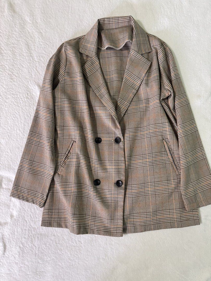 Brown Plaid Double Breasted Blazer Jacket (Category: Coats, Jackets and Outerwear) located in Manila. Submitted by mmilaomls (Listing ID 1470404791, Image 1). Description: - Style: Double-breasted blazer with lapel collar - Pattern/Color: Brown and black plaid - Features: Two front pockets, easy to layer - Measurements (laid flat): Pit-to-pit 18.5", Length 27", Sleeves 22" - Occasion: Perfect for workwear or casual outings.