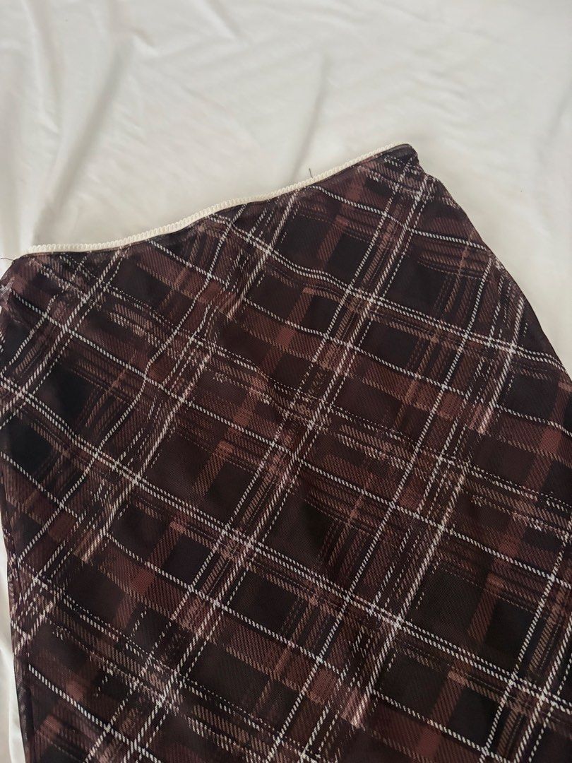 Brown plaid mesh skirt (Category: Skirts) located in Las Pinas. Submitted by thriftedfinds_ (Listing ID 1470354884, Image 2). Description: - Style: Brown plaid mesh midi skirt - Details: Lettuce hem trim, fully lined - Size: Large - Material: 94% polyester, 6% elastane - Origin: Made in China.