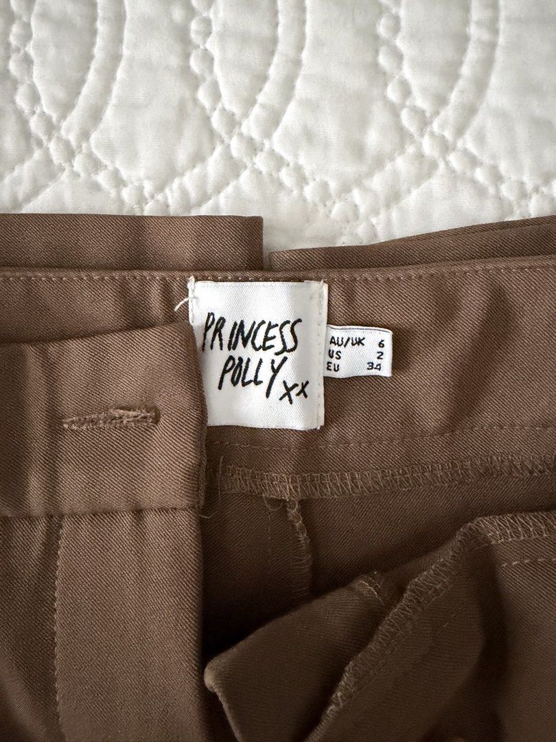 Brown Princess Polly Trousers (Category: Other Bottoms) located in Quezon City. Submitted by kelangot (Listing ID 1470424691, Image 2). Description: Selling this item in great condition! Brand: princess polly Size: US 2 Condition: worn only twice or thrice Color: brown RFS: decluttering 📦 Shipping: C/O buyer 💸 Payment: GCash, BPI, or GoTyme Feel free to message me for inquiries Strictly no cancellations, returns, or refunds. Happy shopping! ♡.