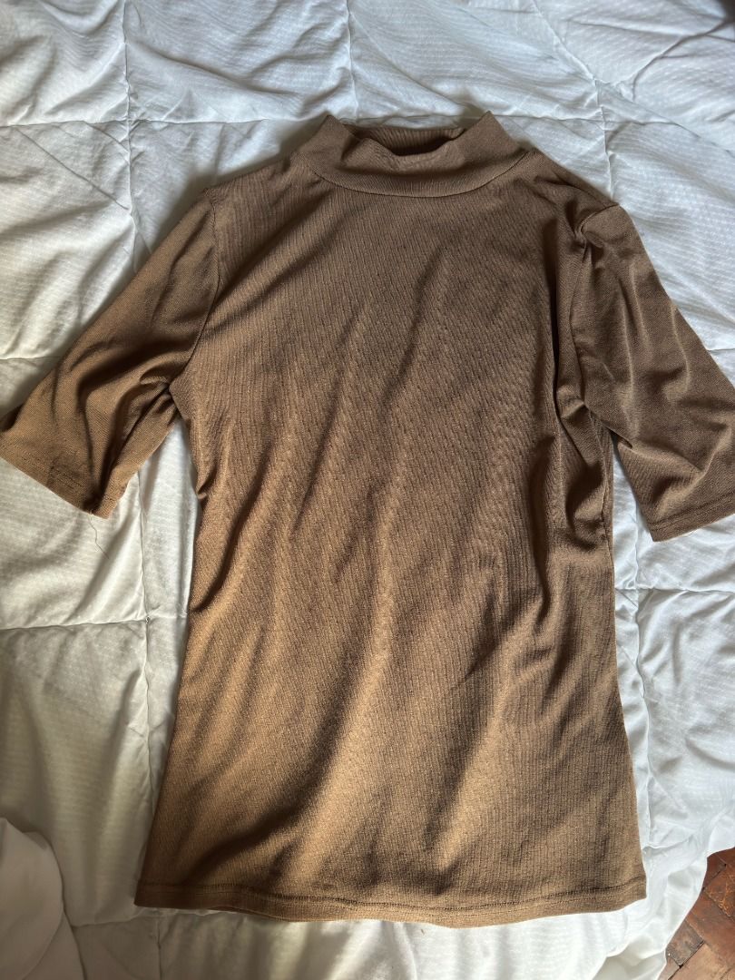 Brown ribbed mock neck top short sleeve (Category: Blouses) located in Cebu City. Submitted by _t.rix (Listing ID 1470383318, Image 2). Description: - Color: Brown (Neutral earth tone) - Style: Mock neckline with short sleeves - Fabric: Stretchy ribbed material - Fit: Standard fit through the body - Versatility: Great for layering or wearing on its own.