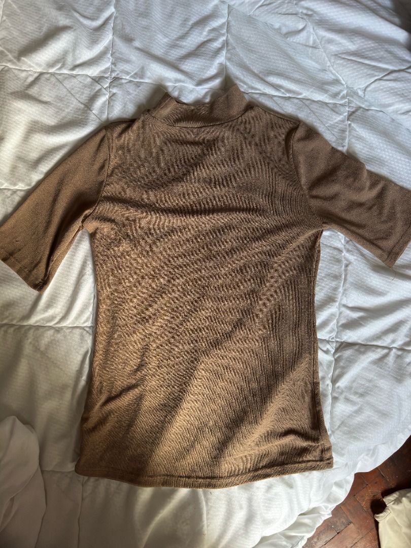 Brown ribbed mock neck top short sleeve (Category: Blouses) located in Cebu City. Submitted by _t.rix (Listing ID 1470383318, Image 1). Description: - Color: Brown (Neutral earth tone) - Style: Mock neckline with short sleeves - Fabric: Stretchy ribbed material - Fit: Standard fit through the body - Versatility: Great for layering or wearing on its own.