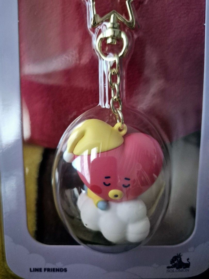 BT21 Tata Figure Keyring LINE FRIENDS (Category: Character Goods) located in Makati City. Submitted by neri_11 (Listing ID 1470449164, Image 2). Description: - Official Line Friends BT21 Tata figure keyring - Design: Tata in a yellow sleeping hat resting on a cloud inside a clear capsule - Hardware: Premium gold star clasp and chain - Condition: Brand new, stored in original unopened retail packaging - 100% authentic and ready to ship.