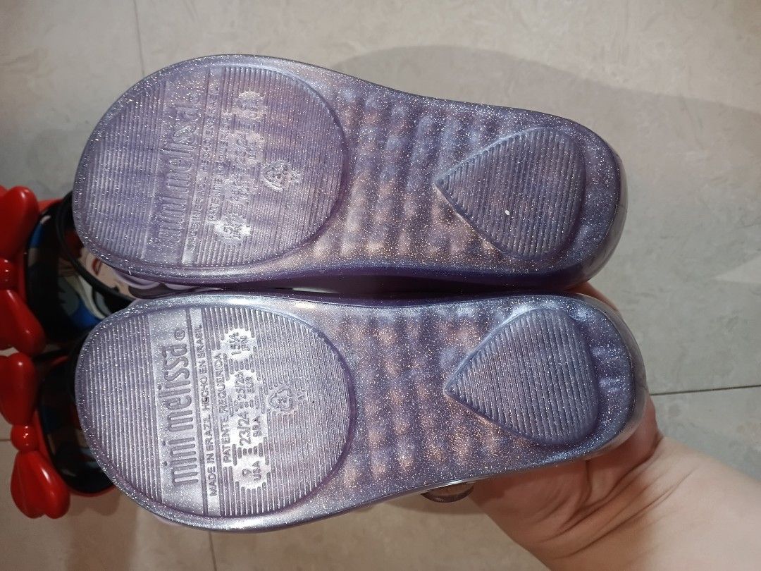 [Bundle] Mini Mel US9 and MMF (Category: Babies & Kids Fashion) located in Quezon City. Submitted by waemierrie (Listing ID 1470511429, Image 3). Description: Sold as bundle, has minimal flaws. bawal po sa maselan, can provide more pics if needed. Original Mini Melissa Glittery Purple Rose US9 ~ missing inner dun sa flower Original Mini Melissa Snow White Sandals US9 ~ has minor tears and dikitin sa red part. faded paint on the buckle. but can be