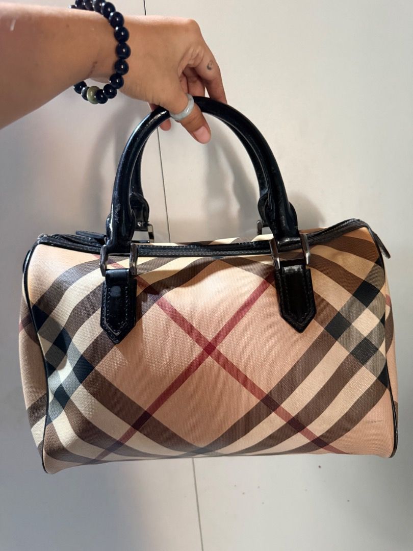 Burberry Check Boston Bag (Category: Luxury Bags & Wallets) located in Manila. Submitted by _outofthecloset. (Listing ID 1470394356, Image 1). Description: - Brand: Burberry - Pattern: Classic Check on Canvas - Trim: Black patent leather with dual top handles - Closure: Secure top zip with metal hardware - Interior: Fabric-lined with a zippered pocket and authentic Burberry leather tag - Condition: Some visible wear on the handles, the body and m