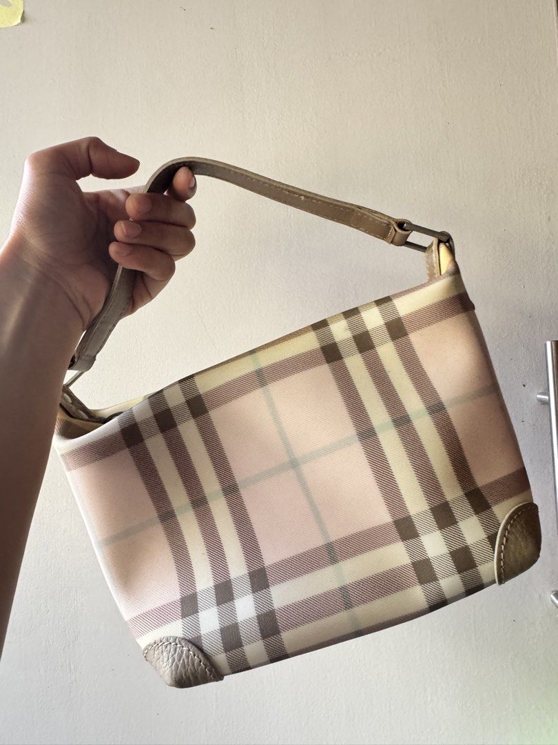 Burberry Check Pink Nylon Shoulder Bag (Category: Luxury Bags & Wallets) located in Rosales. Submitted by thriftingismygame (Listing ID 1470413187, Image 2). Description: - Authentic Burberry shoulder bag in pink check pattern - Durable nylon body with stylish leather trim and top handle - Secure zipper closure with engraved Burberry metal pull - Compact and lightweight size ideal for daily essentials - Condition note: Minor discoloration stains 