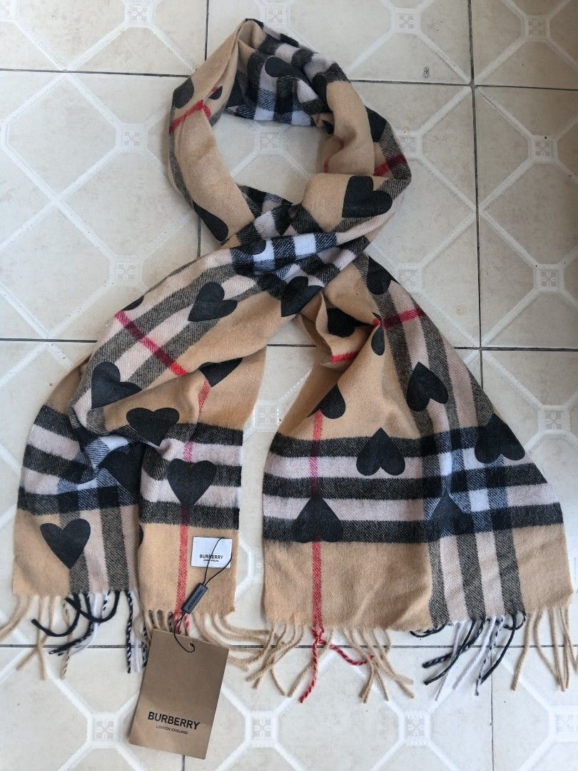 Burberry Check Scarf with Hearts (Category: Scarves) located in Manila. Submitted by grandflower-547aee (Listing ID 1470409382, Image 1). Description: - 100% authentic Burberry winter scarf - Iconic camel check pattern accented with trendy black heart prints - Made from ultra-soft 100% Australian wool - Finished with stylish fringe ends featuring multicolored threads - Brand new with original store tags attached — perfect for gifting or treating 