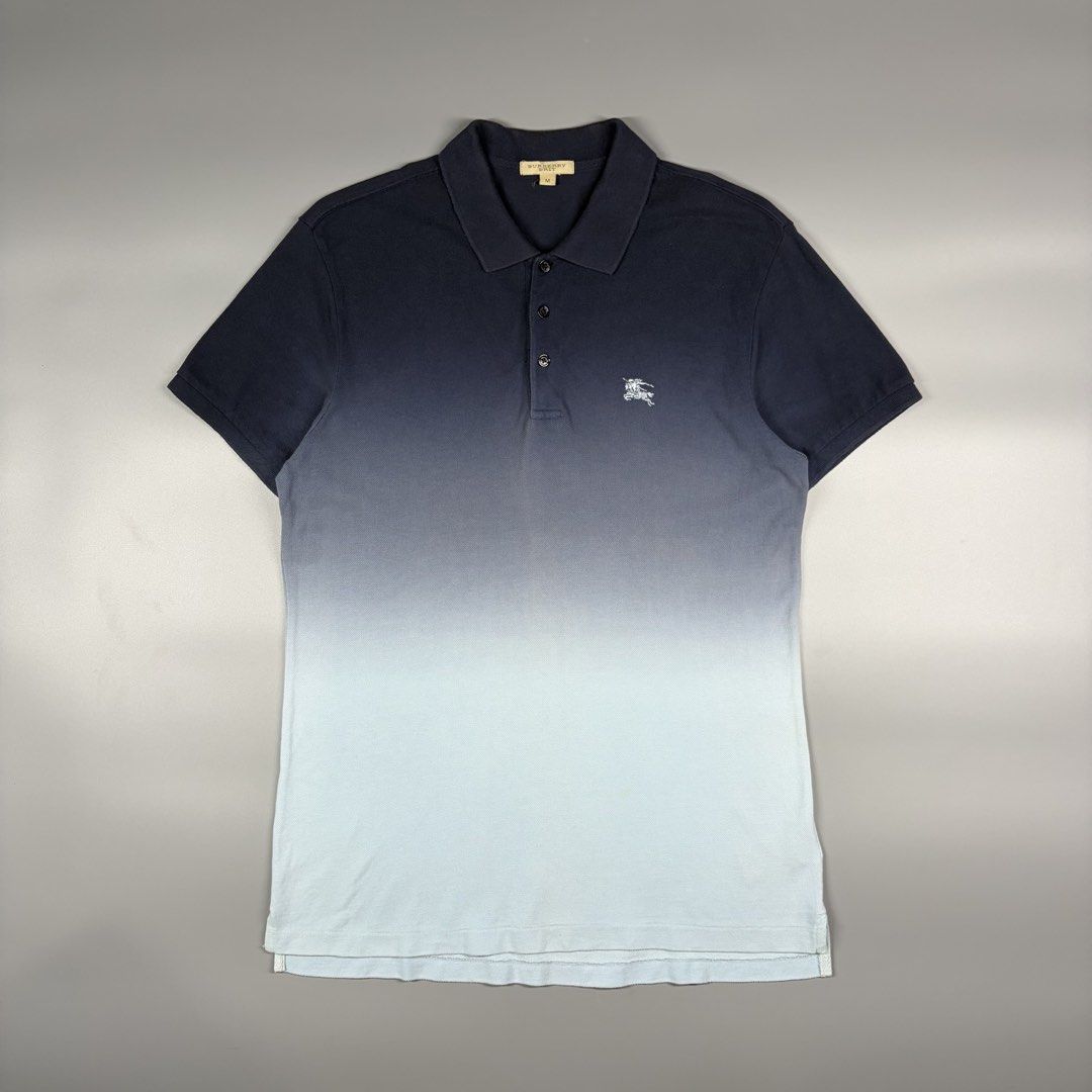 Burberry Dip Dye Poloshirtb(Authentic) (Category: Luxury Apparel) located in Cavite. Submitted by onebeancent (Listing ID 1470457275, Image 1). Description: Size: Medium Dimension: 19" Width | 28" Length Color: Navy Blue & Sky Blue Color Rate: 9.8/10 Issue: None Condition: Like new‼️ Price: 1,280php Additional Shipping Fee (J&T Small Pouch) 75php Luzon 100php visayas 120php mindanao.