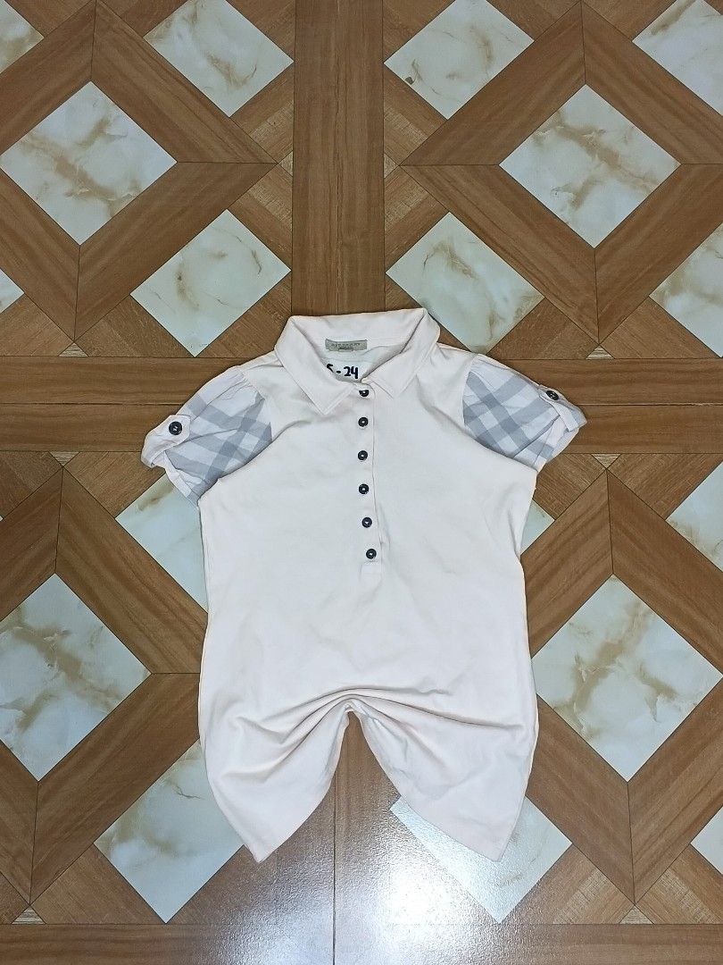 Burberry Light Pink Polo Shirt Size S (Category: Blouses) located in Manila. Submitted by dp.finds (Listing ID 1470501321, Image 1). Description: - Brand: Burberry - Color: Light pink - Size: S (Bust: 85cm) - Material: 98% cotton, 2% elastane for a comfortable stretch - Design: Classic button placket with trendy checkered pattern and button tabs on short sleeves - Care: Machine washable - Condition: Excellent.