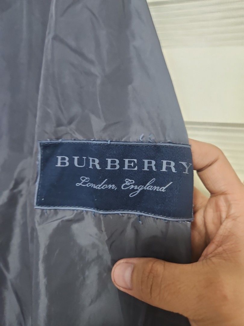 Burberry London England Nylon Zip Jacket (Category: Coats, Jackets and Outerwear) located in Santa Maria. Submitted by rommelmateo (Listing ID 1470531839, Image 2). Description: - Brand: Burberry London England - Color: Dark grey - Material: 100% polyamide (outer) - Lining: Iconic Burberry check print - Closure: Full front zip - Pockets: Convenient side zippered pockets - Origin: Made in Thailand - Condition: Clean and well-maintained overall.