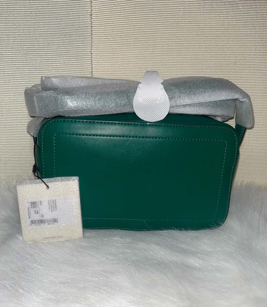 Calvin Klein Camera Bag Emerald Green (Category: Cross-body Bags) located in Imus. Submitted by maria_pilayo (Listing ID 1470434179, Image 2). Description: - Brand: Calvin Klein - 💯 % Authentic - Style: Camera bag in rich emerald green - Material: Smooth leather with debossed front monogram - Dimensions: 20cm (L) x 12cm (H) x 7cm (W) - Condition: Brand new, unused, fresh from storage - Extras: Strap still wrapped in original protective foam, bra